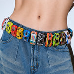 Load image into Gallery viewer, Colorful toy car belt worn by a person with a white flower accessory.
