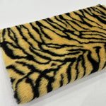 Load image into Gallery viewer, A close-up of a yellow faux fur material with a black tiger stripe pattern, shown on a white background with Chinese text in the top-left corner.
